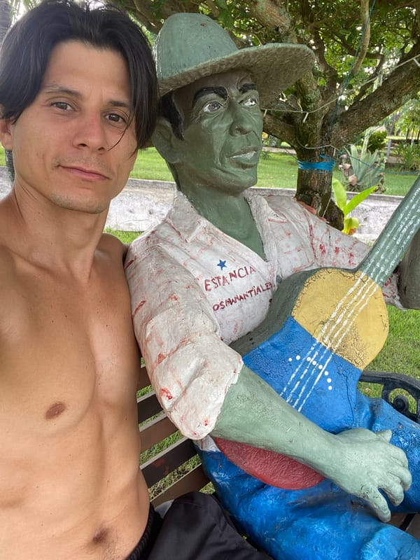 Man takes selfie with statue in Vallecito, Venezuela
