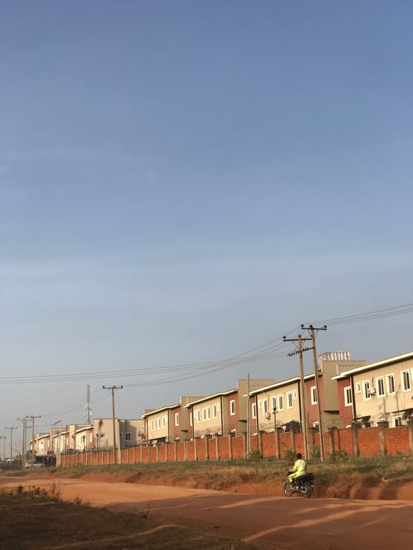Morning street life documented on dirt road in Abuja