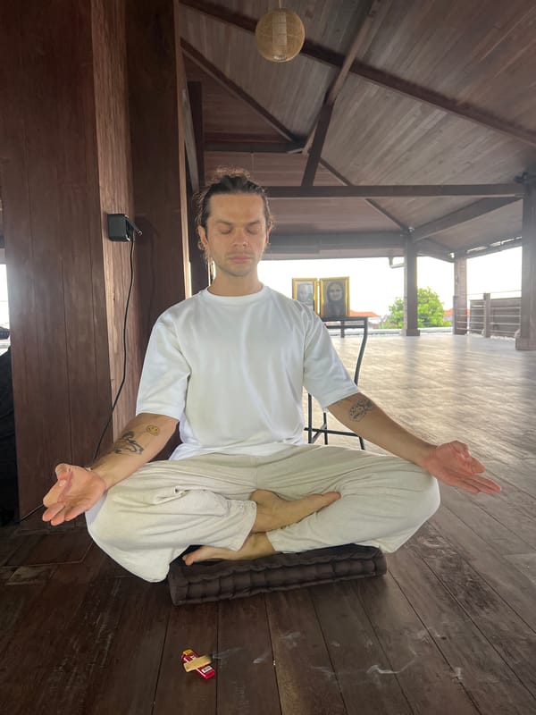 Man practices yoga at tropical resort in Mengwi, Indonesia