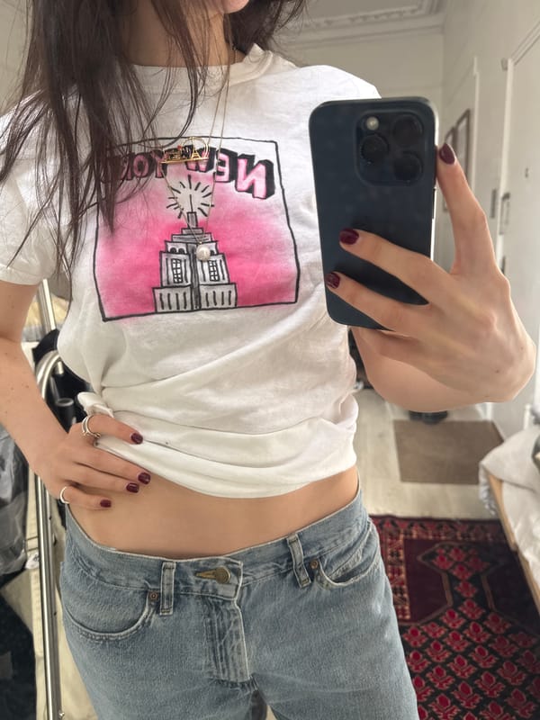Woman takes selfies in Empire State Building shirt in NYC