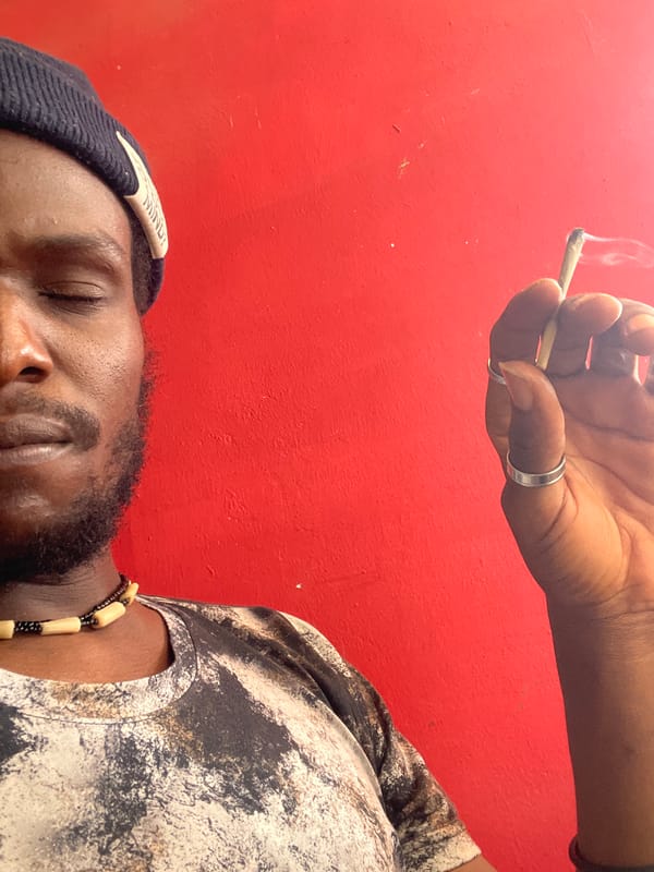 Person rests while cigarette held overhead in Jos