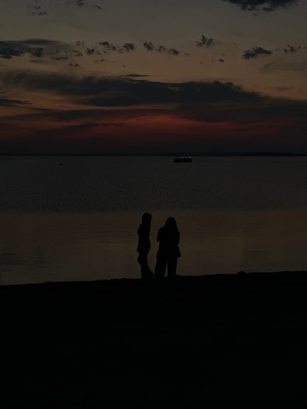 Kokshetau waterfront at golden hour, landmarks lit up