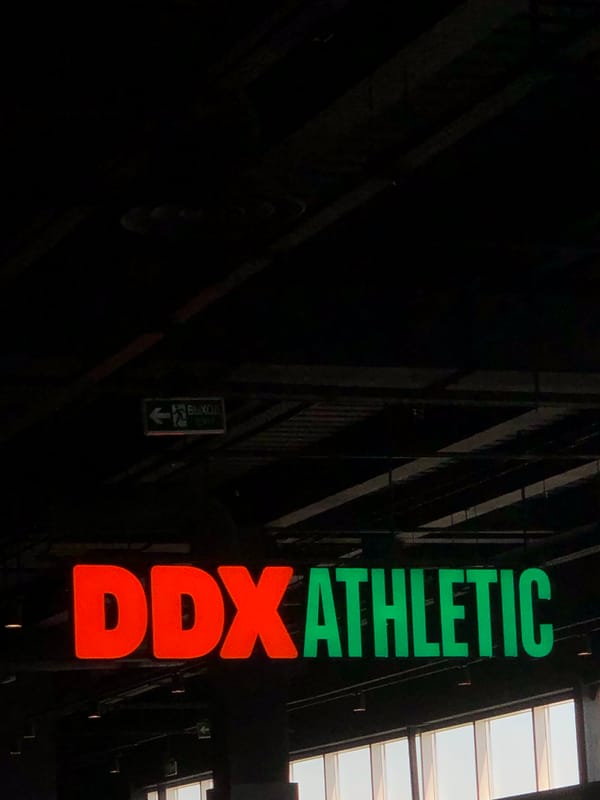 Illuminated DDX Athletic sign observed in Krasnoyarsk indoor venue
