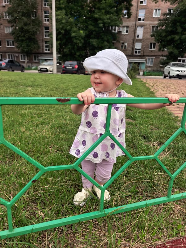 Toddler in polka dot dress on a sunny Sterlitamak lawn