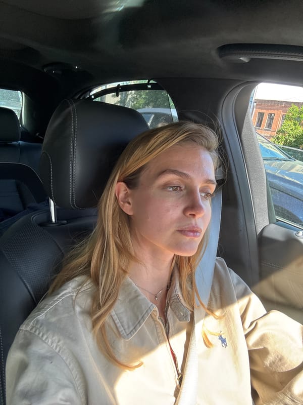 Woman rests in car during bright sunny afternoon