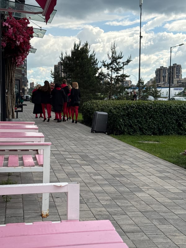 Red-themed group gathering in modern urban development with coffee stops