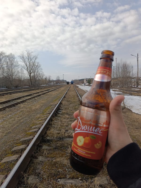 Man enjoys soft drink by railway tracks in Andreyevo
