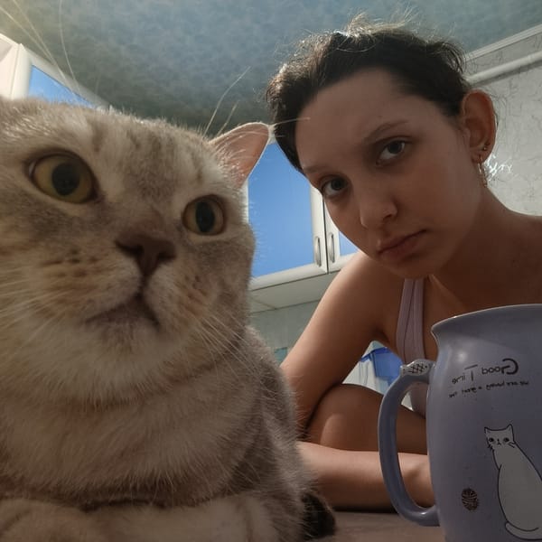 Woman takes indoor selfie with cat