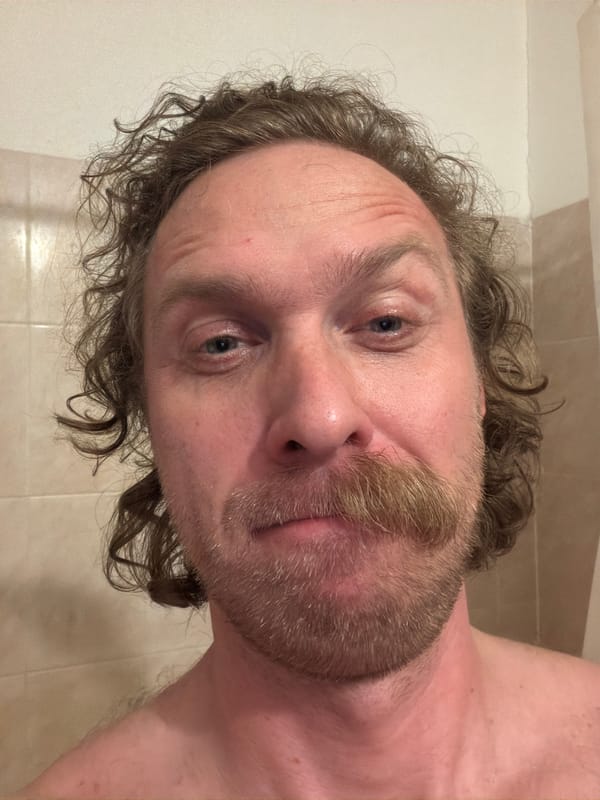Man poses for photo in Saint Petersburg bathroom