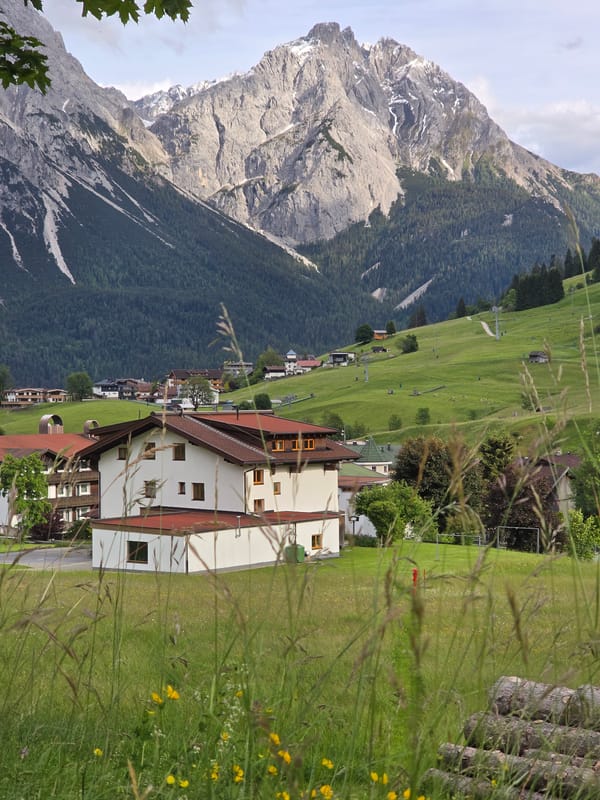 Alpine village Lermoos documented with trains, meadows, Zugspitze backdrop