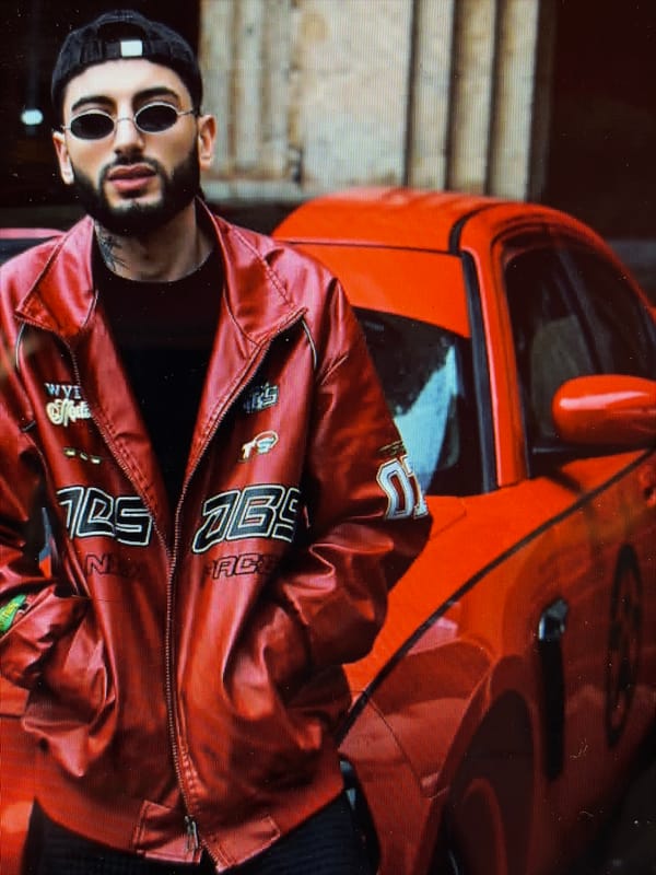 Man poses with red sports car in Charentsavan