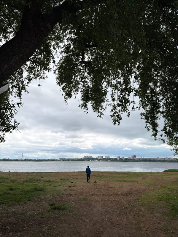 Woman documents overcast day exploring Izhevsk parks and waterfront