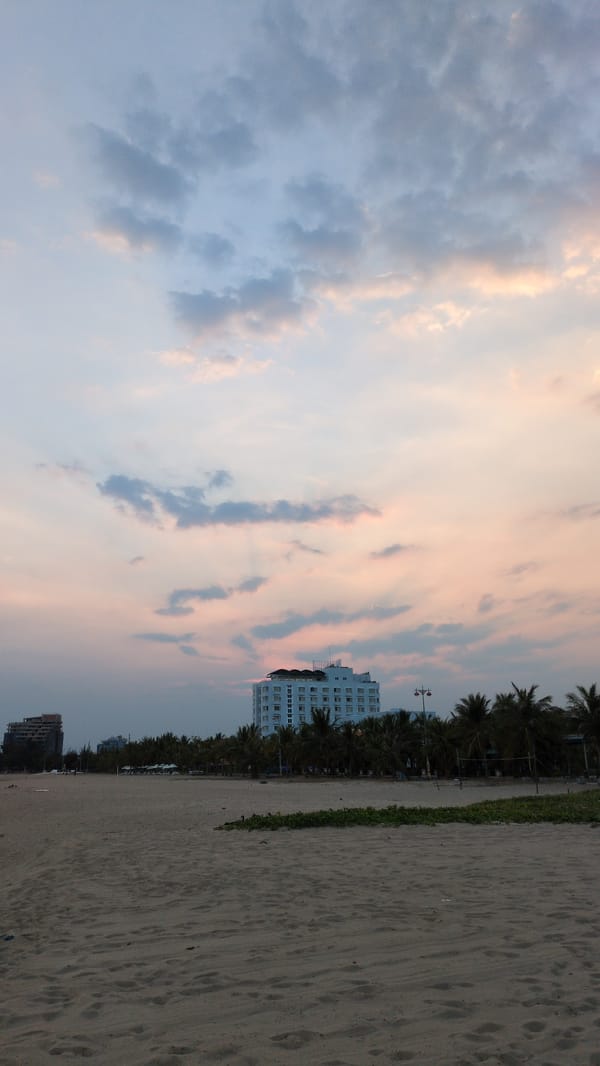 Beach scene with resting poodle and couple in Khánh Hải