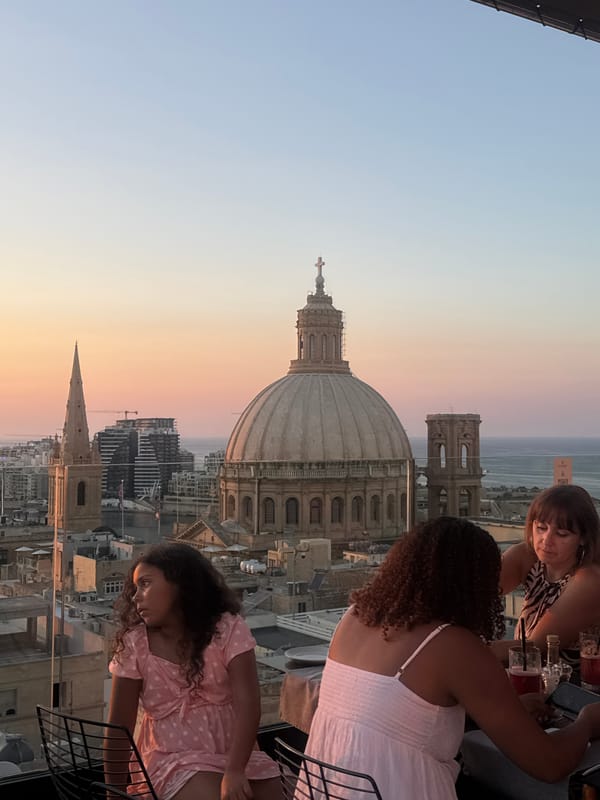Rooftop sunset views over Valletta from a poolside setting
