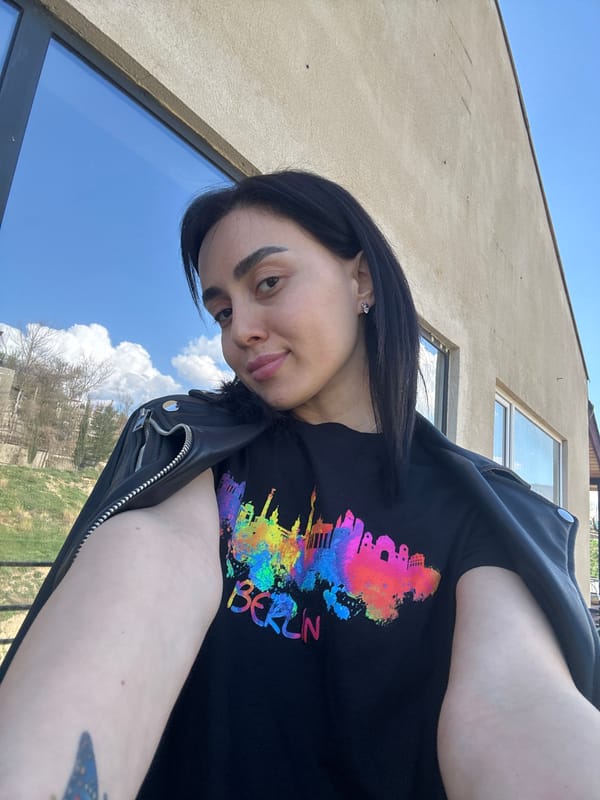 Woman takes selfie under blue skies in Tbilisi