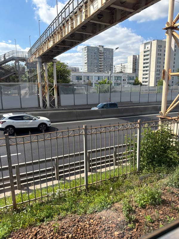 Street-level and aerial views of a Moscow road on a sunny day