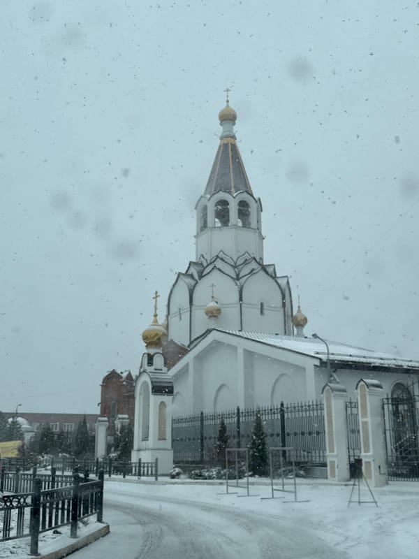 Spring snowfall blankets Orthodox church complex in Perm, Russia