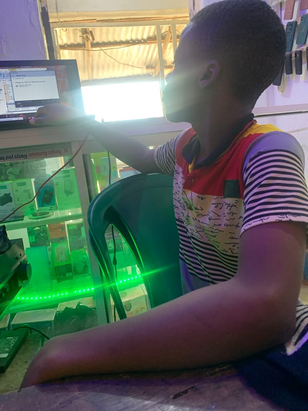 Youth takes selfies in electronics shop in Nigeria