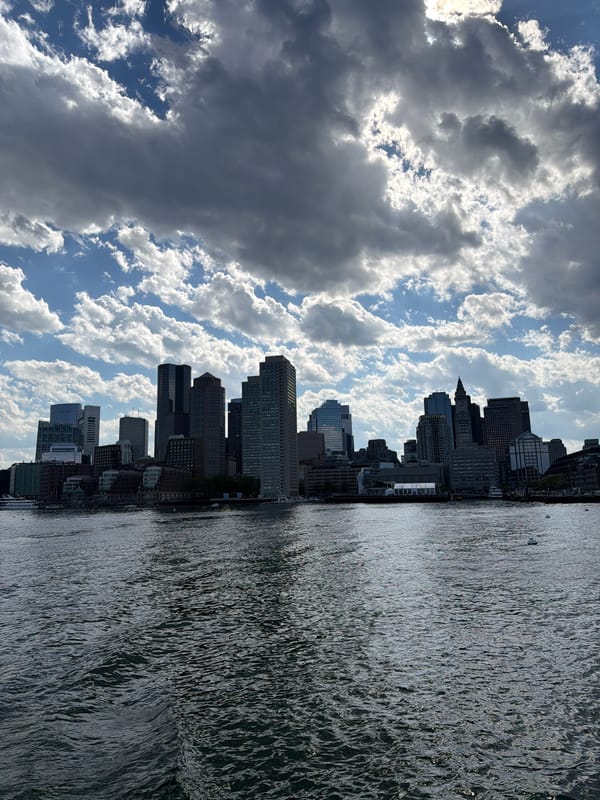 Boston skyline captured from harbor on cloudy evening