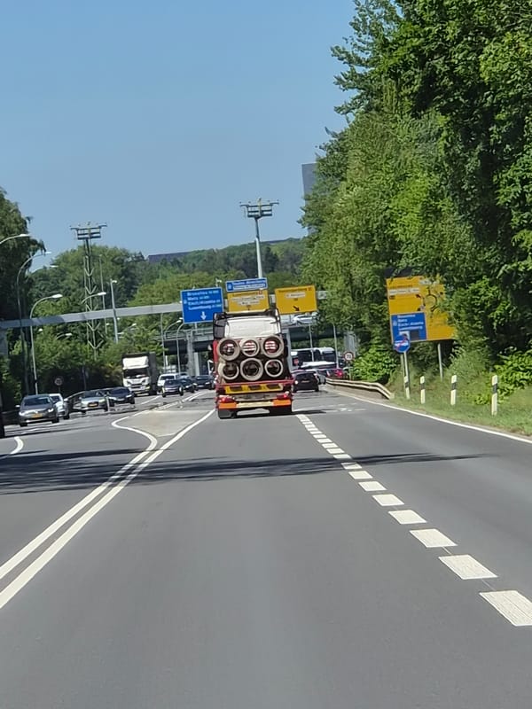 Semi-truck carries metal cylinders on Luxembourg highway