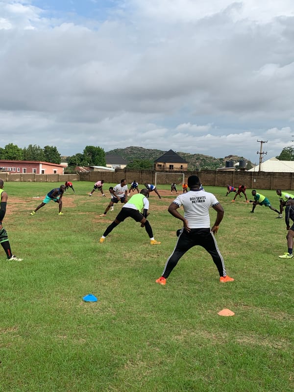 Soccer training session on a grass pitch in Jos, Nigeria
