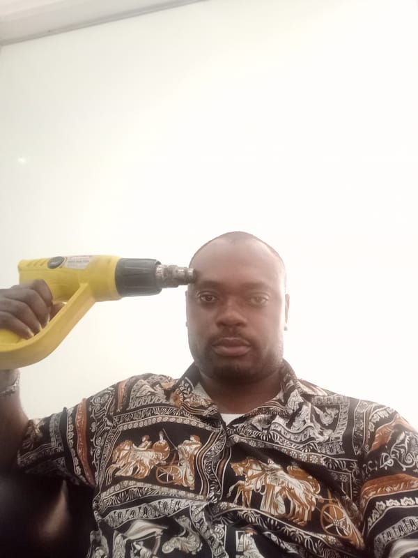 Man uses heat gun device in Nigerian workspace