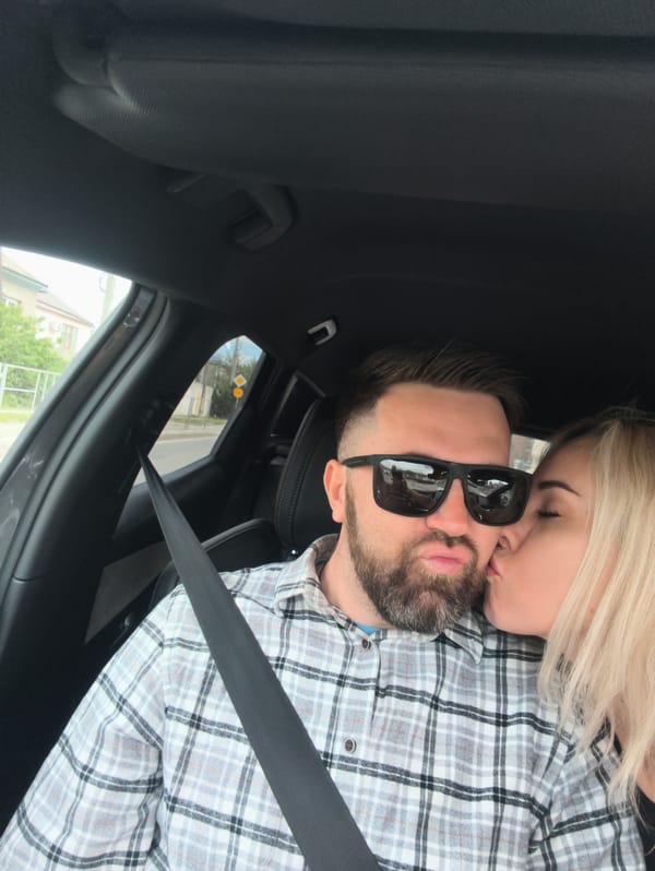 Couple takes playful selfies in car, scooter rider spotted