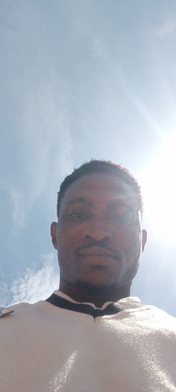 Man takes selfies under blue sky in Adankolo