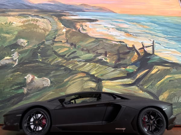 Toy cars and paintings photographed in Hazlemere garden setting