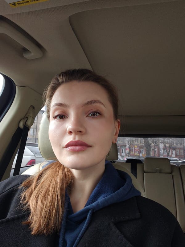 Woman in dark coat observed in driver's seat