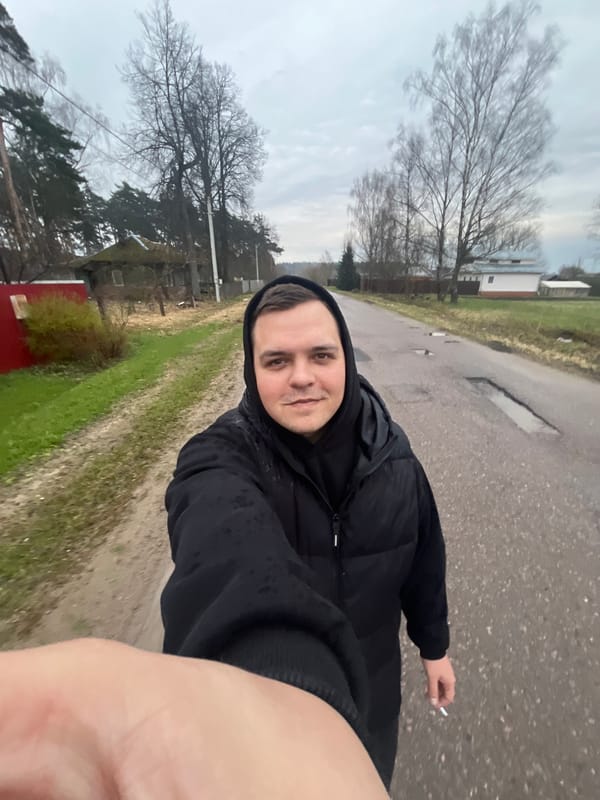 Man in black jacket observed on wet road in Раздолье