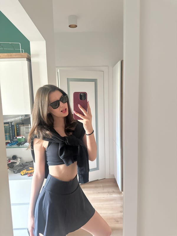 Woman takes mirror selfie in domestic indoor setting