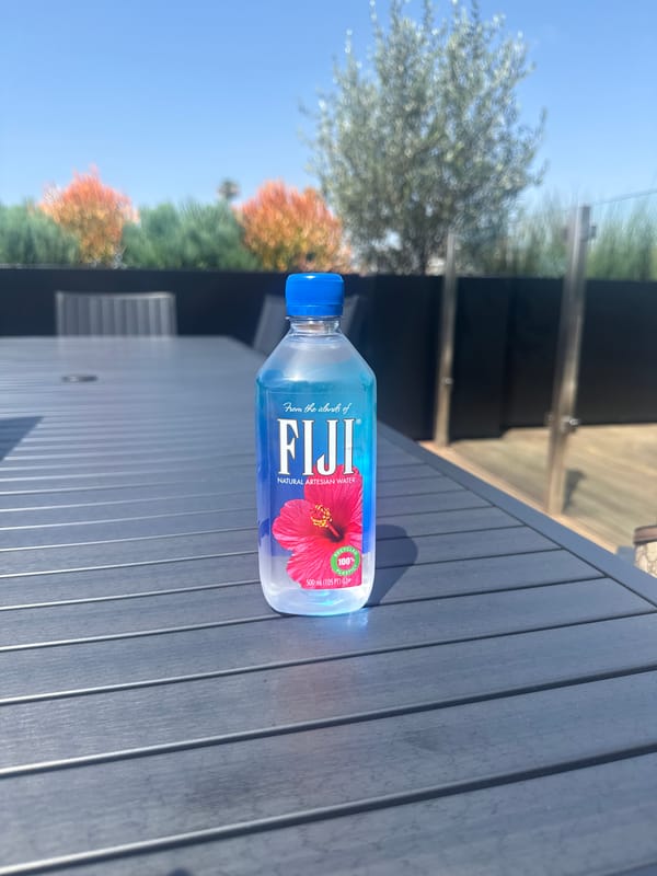 Person with FIJI water bottle observed on LA rooftop patio