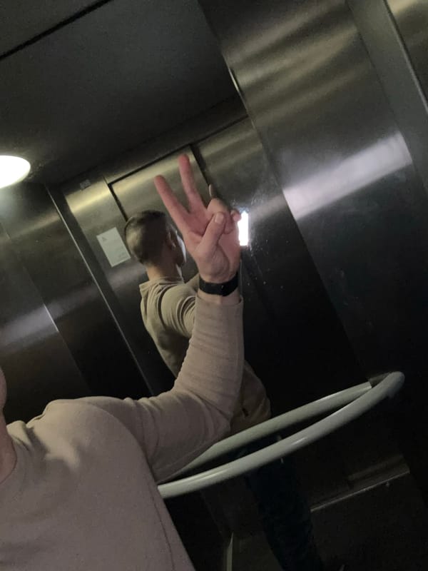 Man poses with peace sign in Sofia elevator
