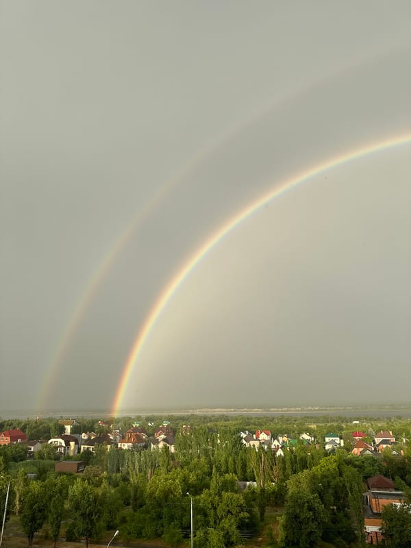 Double rainbow spans village and city skyline near Volgograd