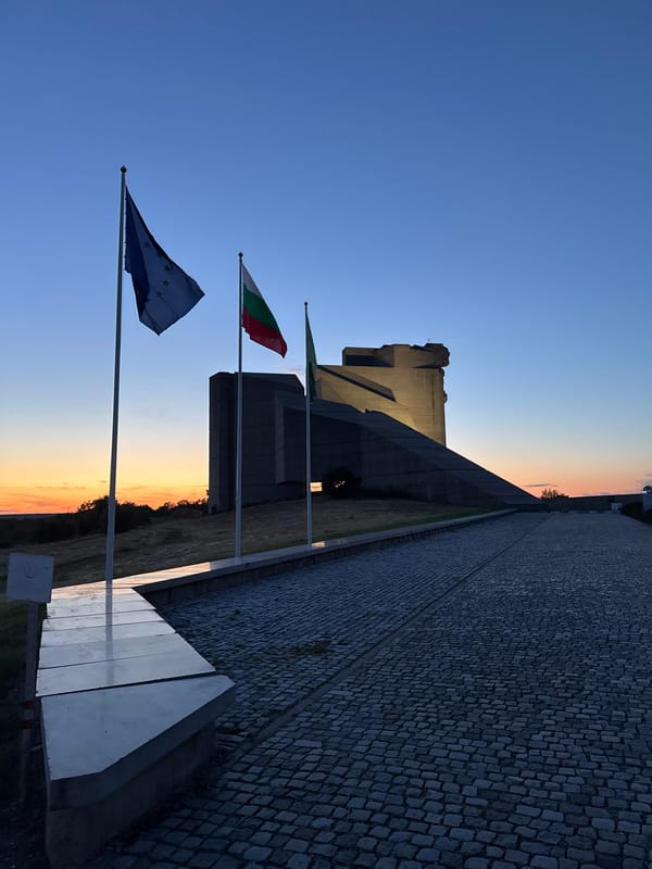 Tourist documents Bulgarian state monument at dusk in Shumen