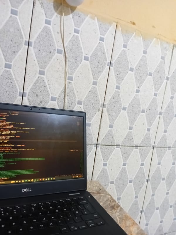 Dell laptop shows flight delay prediction code on floor