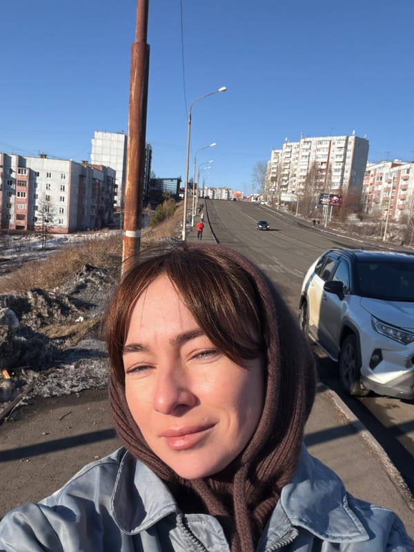 Woman in blue jacket spotted on sunny day in Ust-Ilimsk