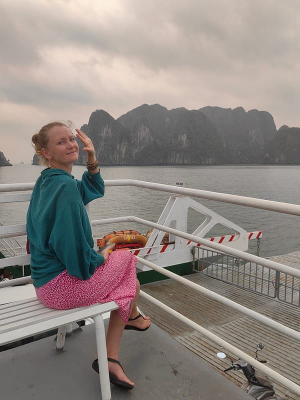 Woman travels by ferry through Vietnam's limestone karst waters