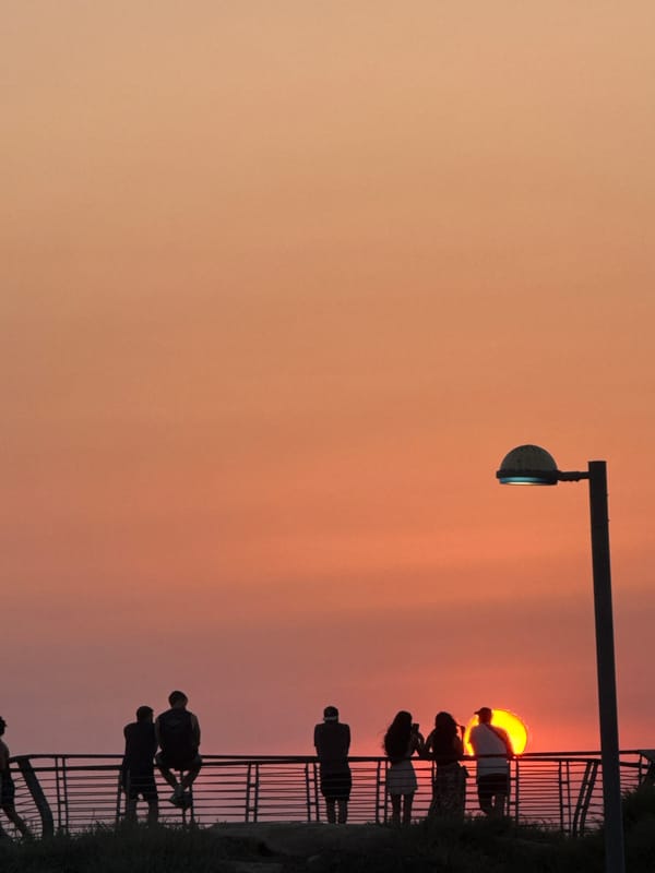 Sunset crowds line the Tel Aviv Mediterranean promenade