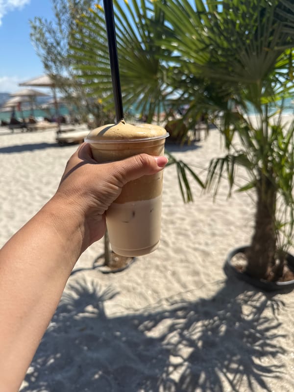 Iced latte at a sunny beach table