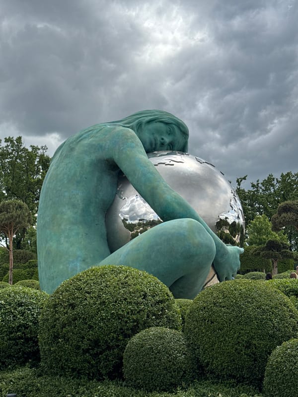 Weathered woman statue holding globe observed in Krasnodar, Russia