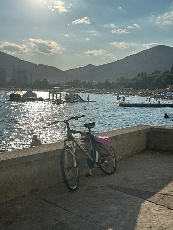 Bicycle parked on Budva's waterfront, Adriatic in the background