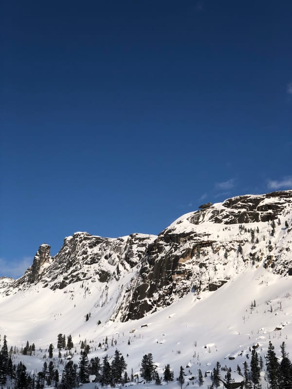 Snow-covered Russian mountains documented under clear blue skies