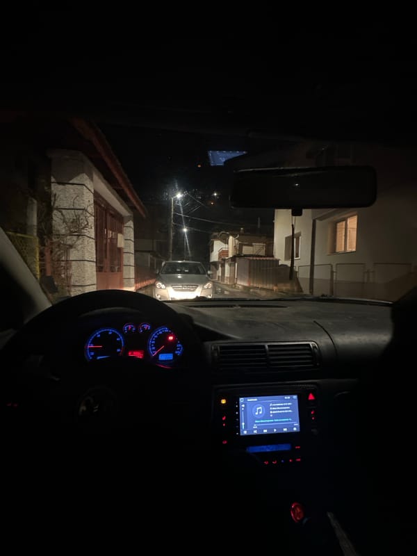 Vehicle navigates narrow street in Smolyan at night