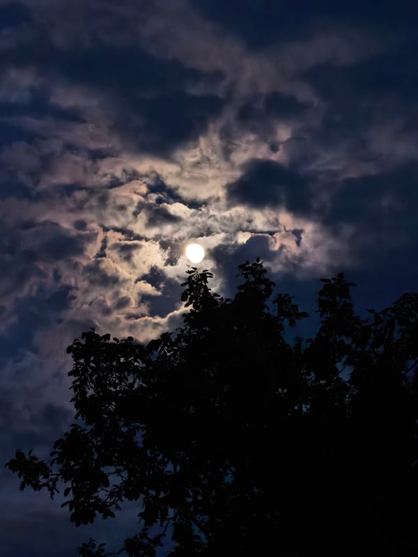 Full moon photographed through clouds in Svishtov, Bulgaria