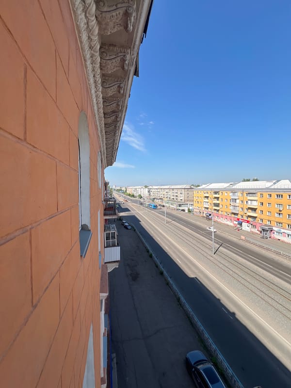 Krasnoyarsk tram street and Soviet-era apartment blocks on a sunny day