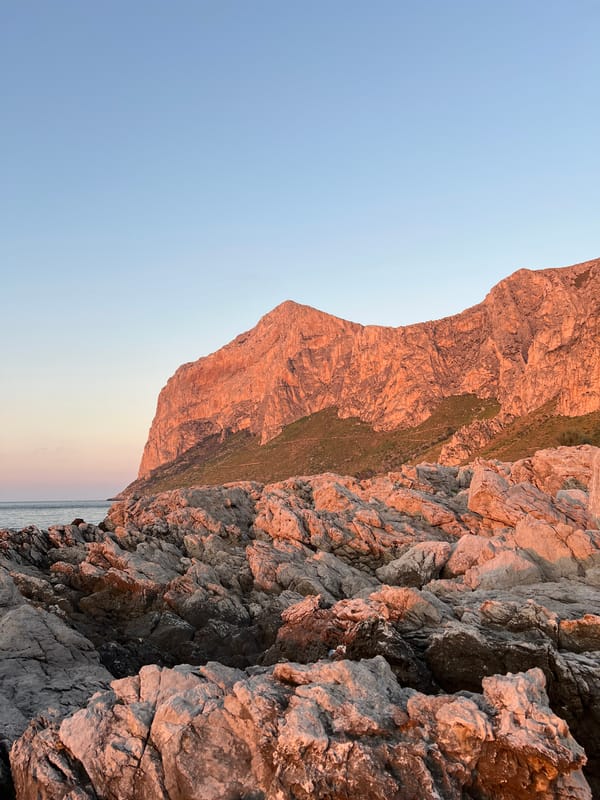 Sunset over a rocky Palermo coastline