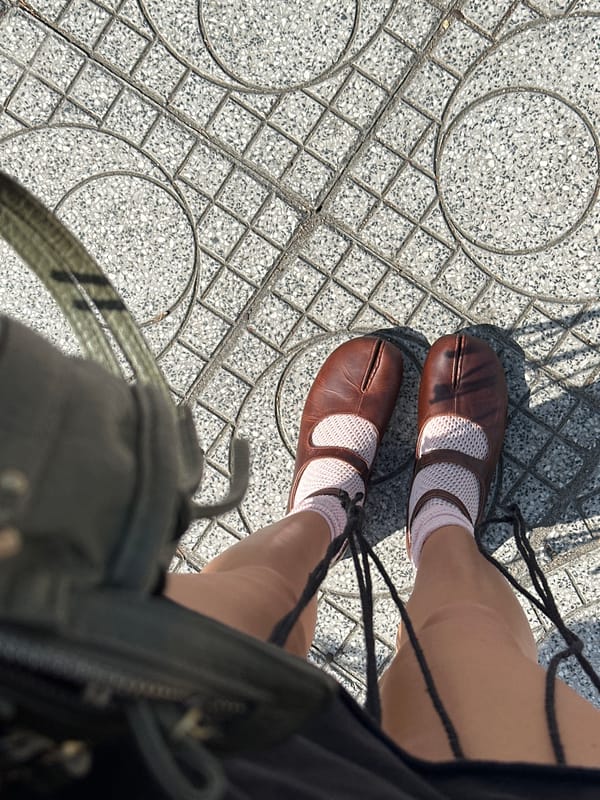 Sidewalk selfie moment in Nha Trang, shoes and street traffic.