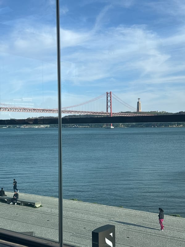 Ponte 25 de Abril bridge photographed through glass in Lisbon